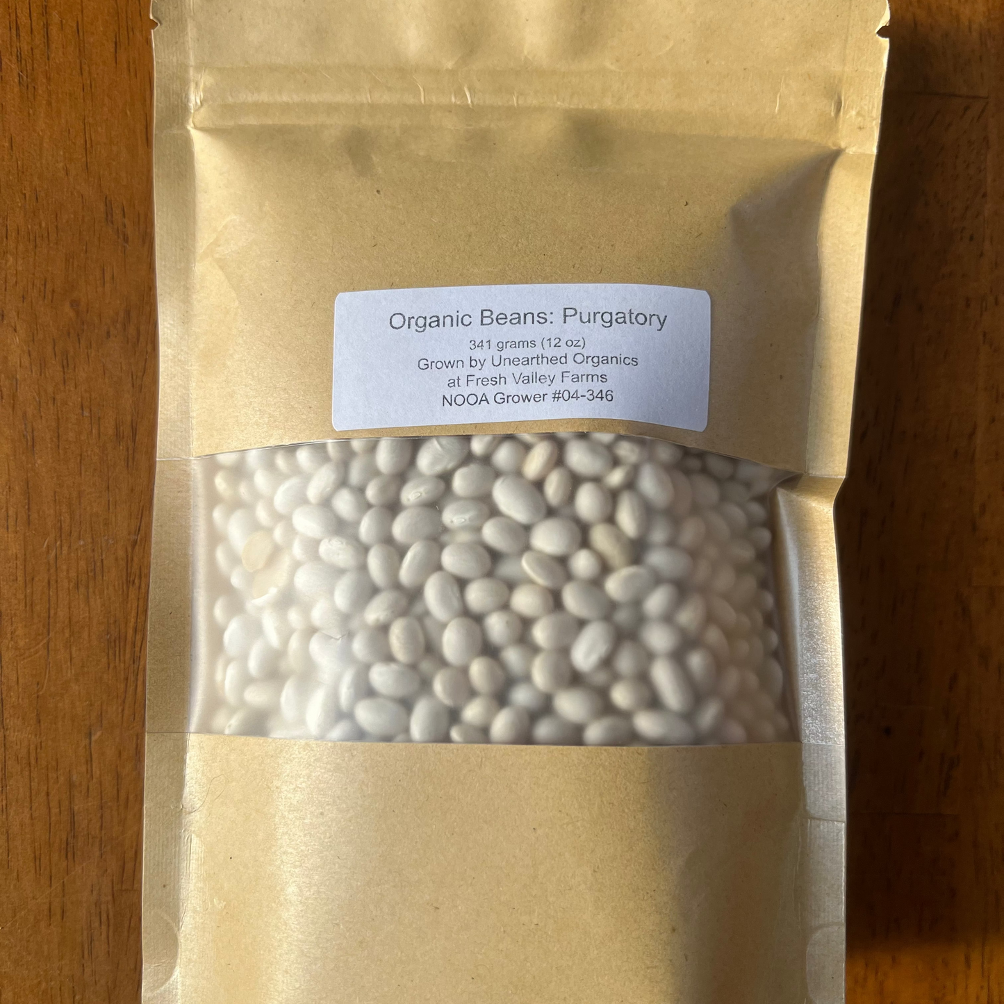 Package of organic beans on a wooden surface