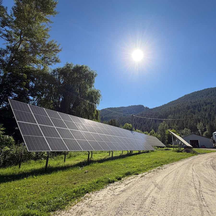 A row of solar panels beside the farm lane at Fresh Valley Farms
